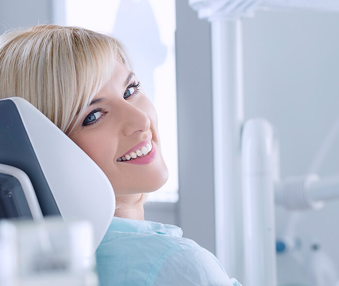 smiling woman sitting in a dental chair