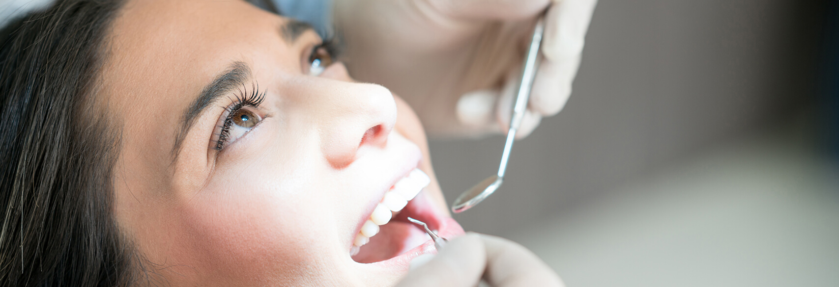woman receiving a dental cleaning and exam