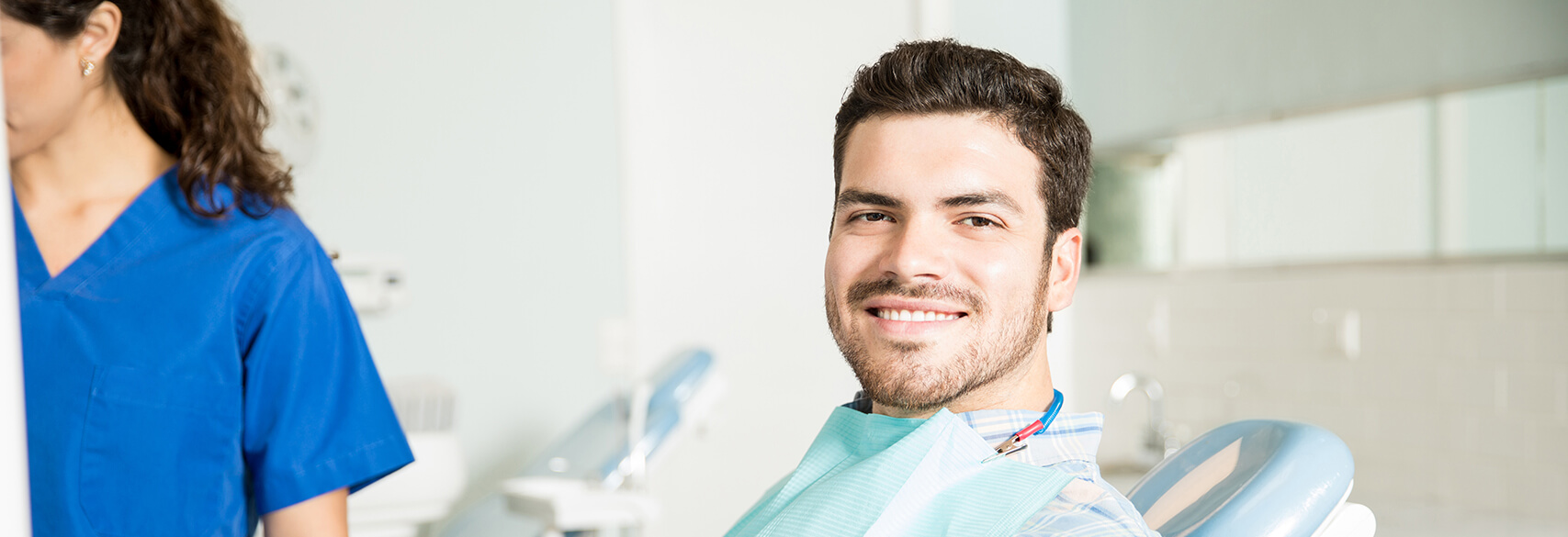 smiling man sitting in a dental chair