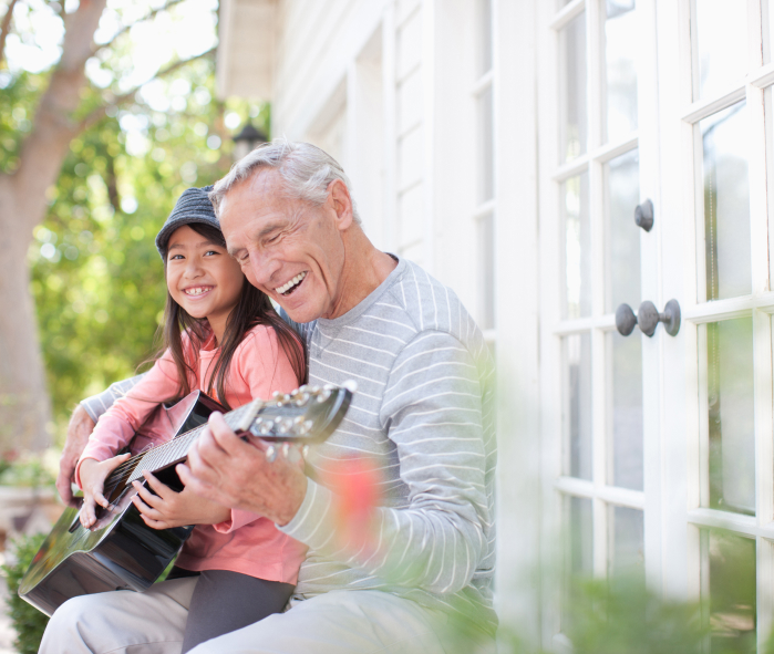 man with child playing guitar