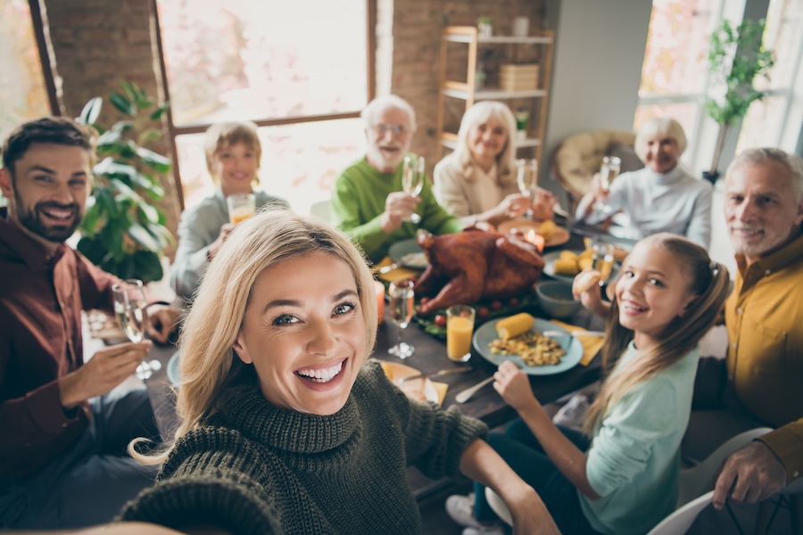group picture during thanksgiving dinner, prep with a holiday smile makeover