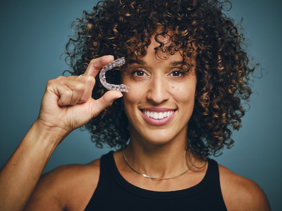 woman with invisalign clear aligners