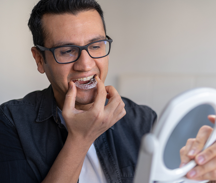 man putting in clear aligner